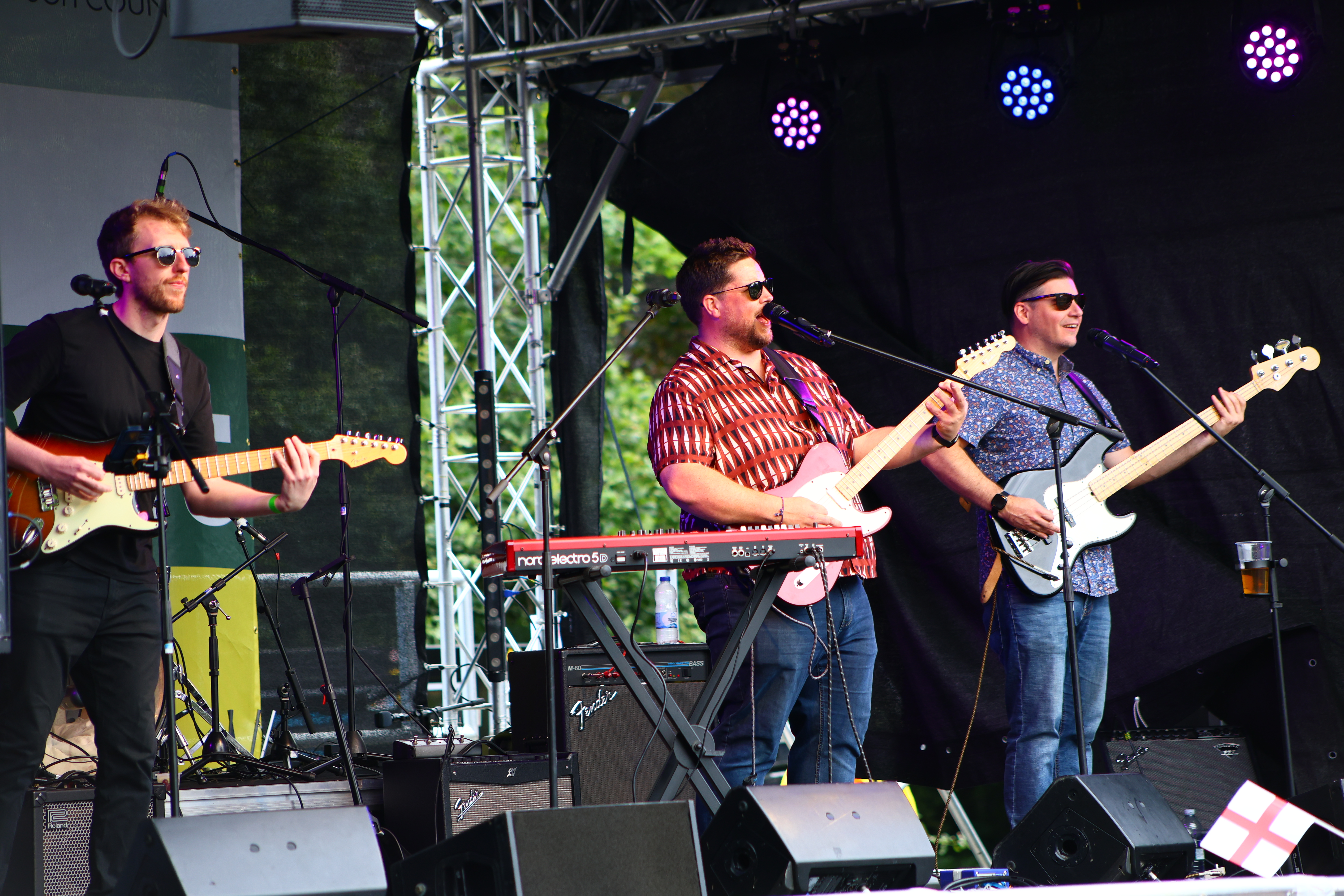 3 people on a stage playing guitar