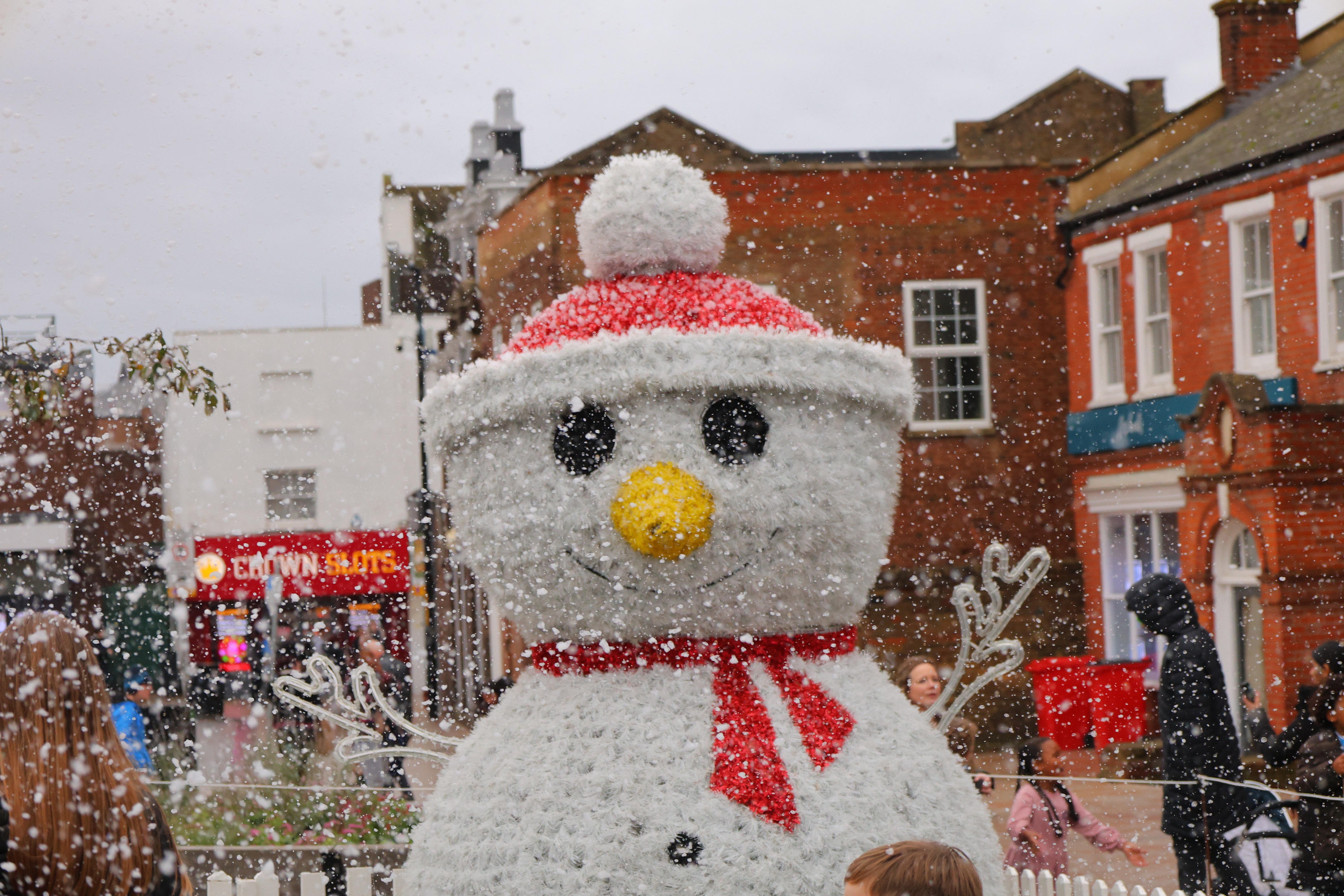 A big light-up snowman with a red hat outside in Dartford