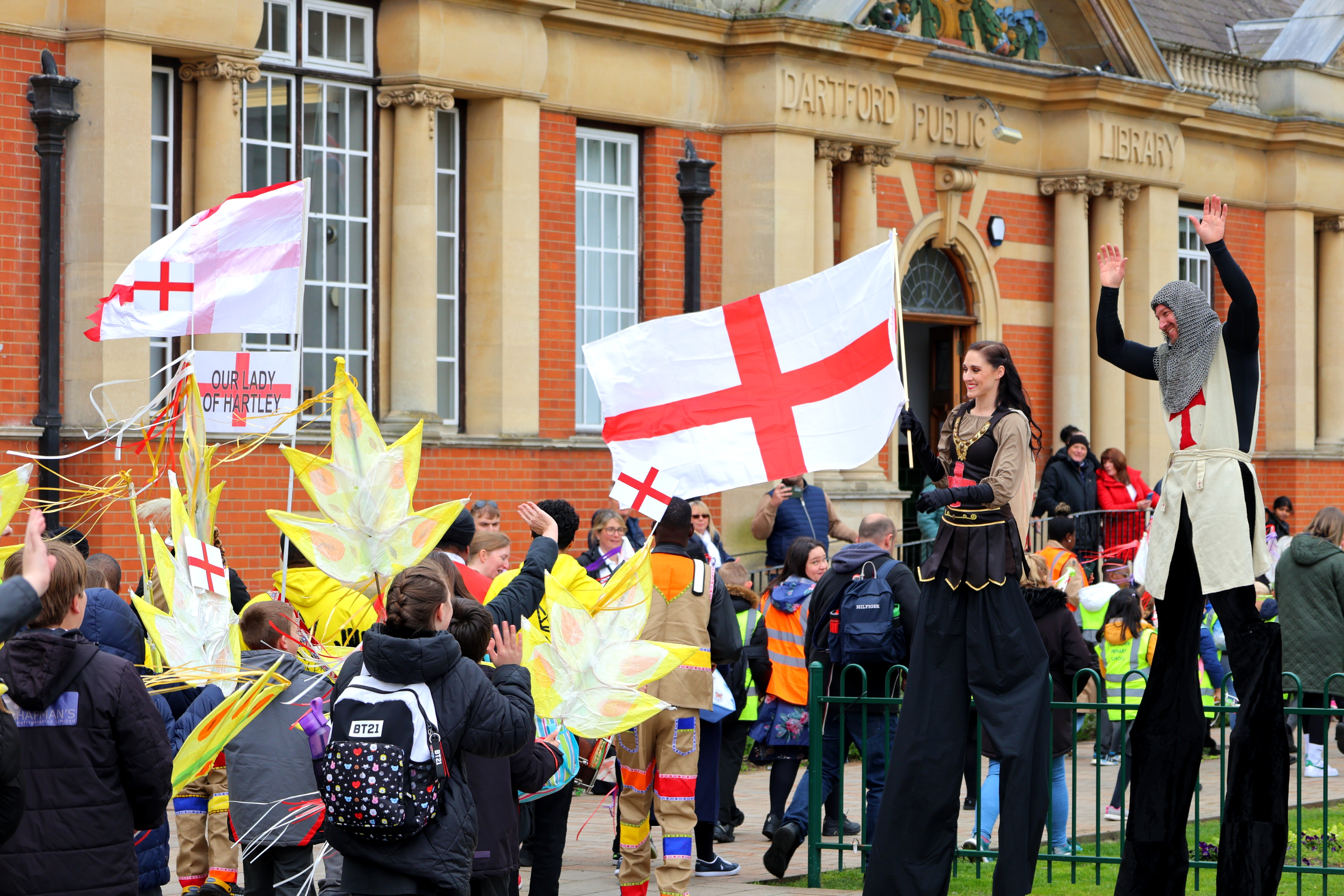 A group of people gathered for St george&#039;s day holding flags